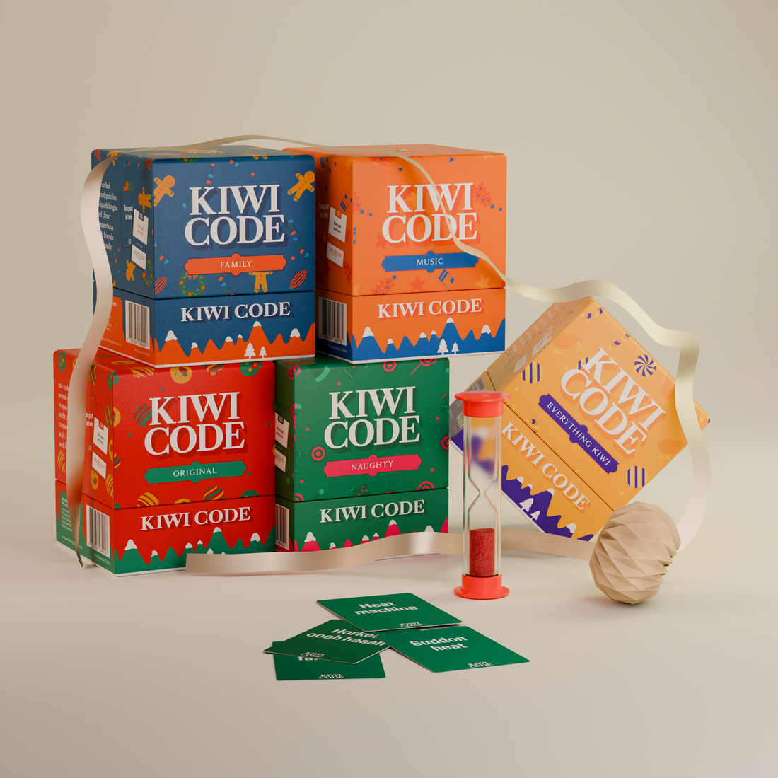 Five Kiwi Code card game boxes with a sand timer, cards, ribbon and a Christmas bauble